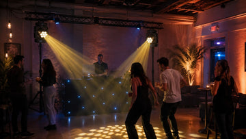 Moving head lights illuminating a DJ dance floor