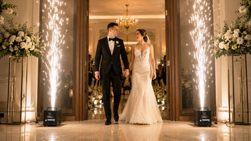 Bride and groom entering between indoor cold spark fountains