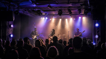 Live band performing under colorful LED stage lights